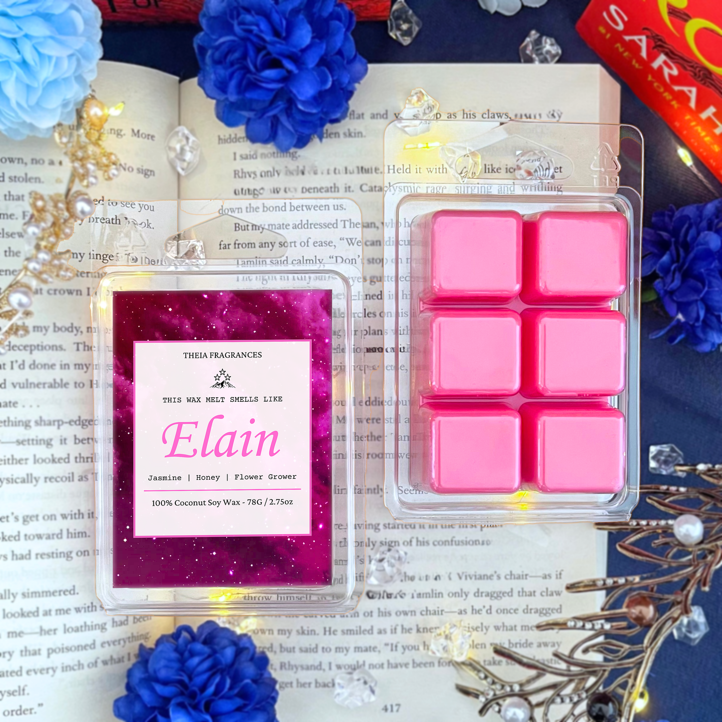 The 'Flower Grower' coconut soy wax candle by Theia Fragrances is demonstrated in the 78G wax melt. The label features a pink galaxy. It is styled on an open book with decorative crystals and flowers.