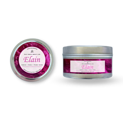 The 'Flower Grower' coconut soy wax candle by Theia Fragrances is demonstrated in the 110G tin candle. The label features a pink galaxy. It is styled on an open book with decorative crystals and flowers.