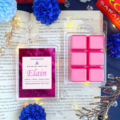 The 'Flower Grower' coconut soy wax candle by Theia Fragrances is demonstrated in the 78G wax melt. The label features a pink galaxy. It is styled on an open book with decorative crystals and flowers.