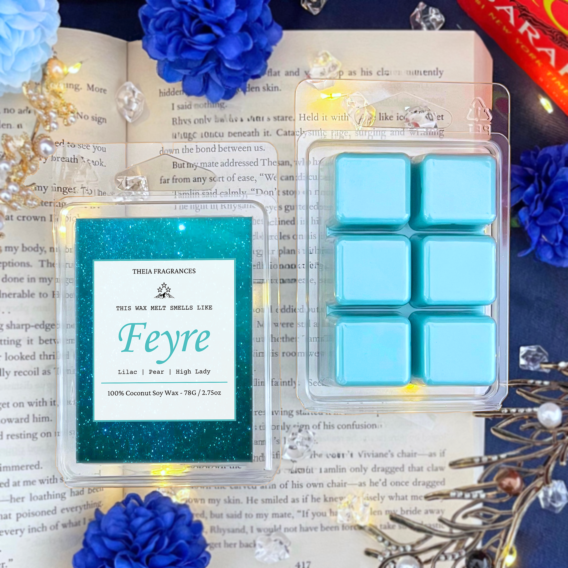The 'High Lady of the Night Court' coconut soy wax candle by Theia Fragrances is demonstrated in the 78G rectangular wax melt. The label features a teal galaxy. It is styled on an open book with decorative crystals and flowers.